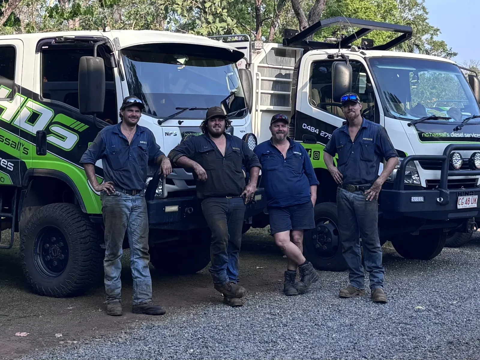 The No Hassall’s Diesel Services crew standing with their branded service trucks and ute in Darwin